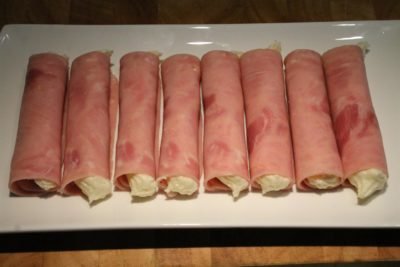 Place the ham rolls on a serving plate.
