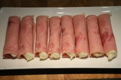 Place the ham rolls on a serving plate.