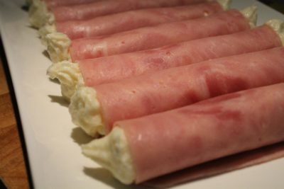 Ham rolls decorated with horseradish cream 